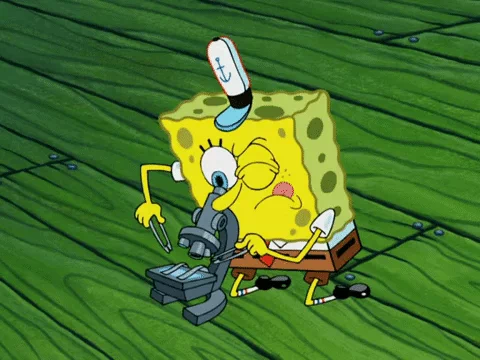 Spongebob looking through a microscope and is surprised by what he sees.