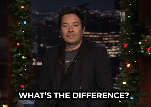 Jimmy Fallon wearing a black hoodie and blazer, shrugging and saying 