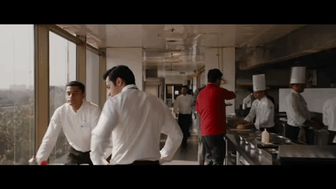 Worker walking through a restaurant and checking on its operations.