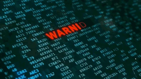 A computer screen filled with lines of code and a red message that says: "Warning! Hacking Detected!"