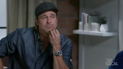 Brad Pitt listening attentively to someone 