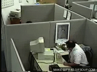 angry office worker smashing his computer with a keyboard