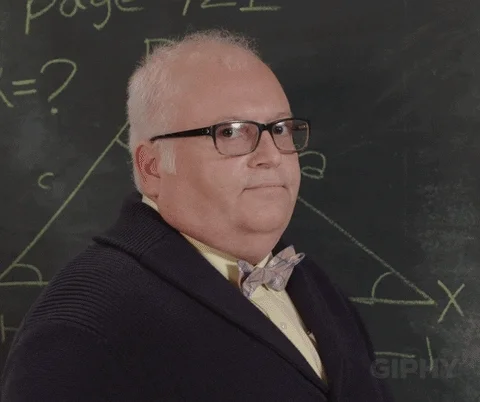 A math professor by the chalkboard gives two thumbs up.