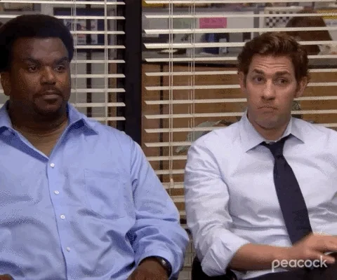 Jim and Darryl from The Office giving a fist bump to each other.