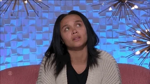 A young woman looking up deep in thought.