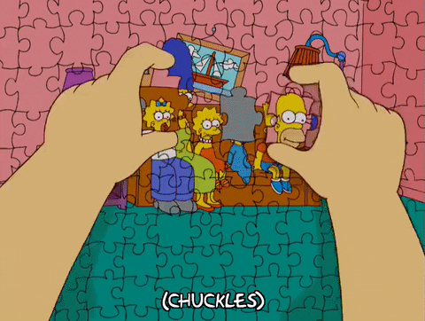 A person has completed a jigsaw puzzle that is a portrait of the Simpson Family