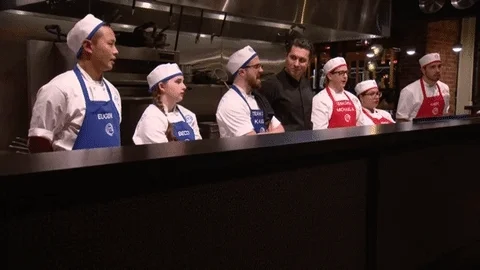 A  group of chefs in a kitchen saying, 