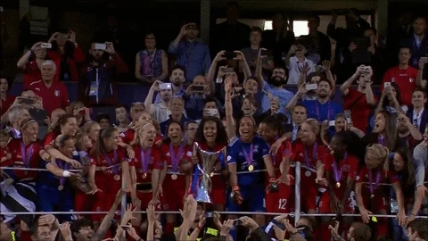 A women's soccer team holding up a trophy