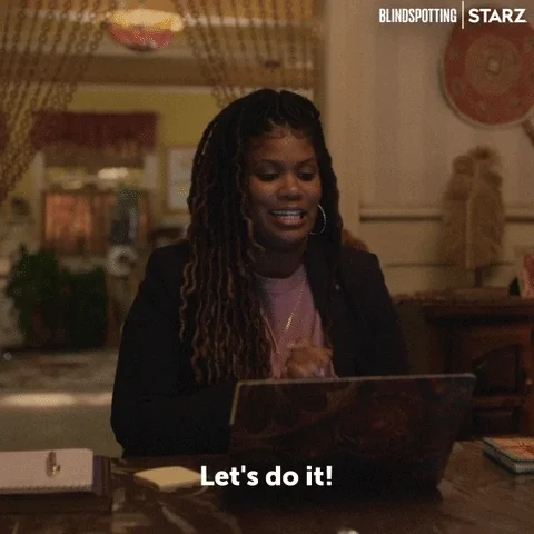 A woman dances in front of a laptop. She says, 