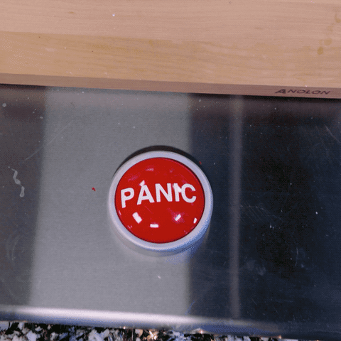 Hand reaching out to press a red button that says 