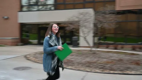 A student runs on campus on her first day at college.