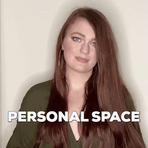 A person indicating personal space by putting their hands forward