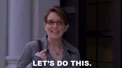 A woman in casual clothing, wearing glasses, She's smiling and encouraging someone off-screen.