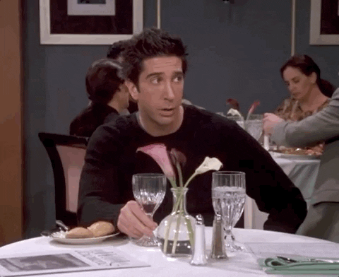 Ross from Friends sitting alone at a restaurant