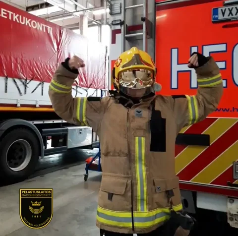 Firefighter posing with arms up