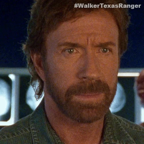 Chuck Norris staring ahead intently.