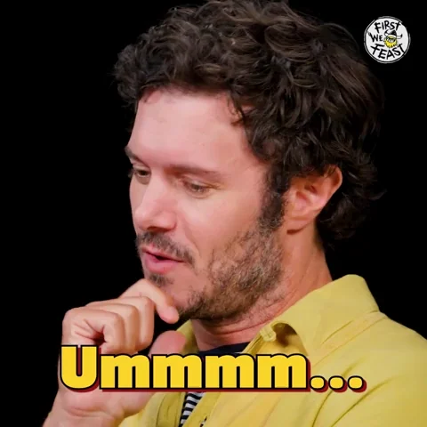 Adam Brody on First We Feast putting a finger on his lip to think and saying, 