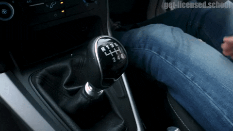 Person, maneuvering gearstick in a car