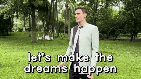 A young man in a garden saying, 'Let's make the dreams happen.'