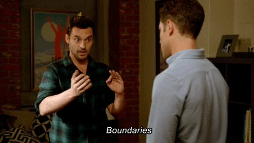 Nick from New Girl wearing a plaid shirt, gesturing in a straight line while saying, 