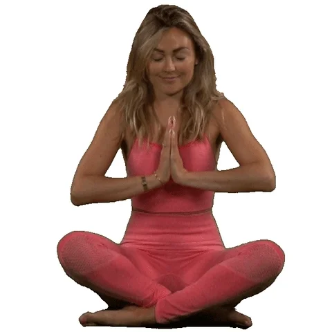 A woman in a seated yoga breathing pose.