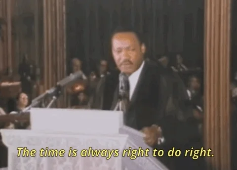 Martin Luther King giving a speeach at a podium saying, The time is always right to do right.'