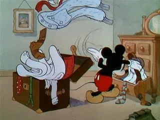 Mickey Mouse packing his suitcase.