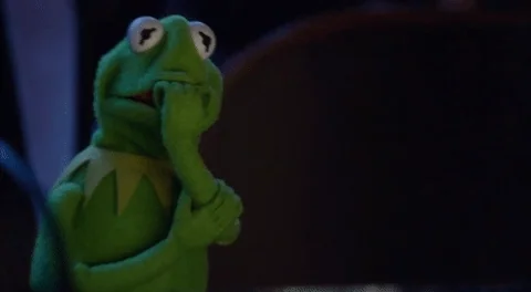 Kermit the Frog trembling with anxiety, biting his nails. 