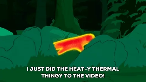 An animation depicting a person glowing red and yellow through a thermal imaging camera while hiding in the woods.