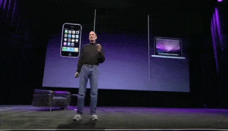 Steve Jobs presenting Apple products at a conference.