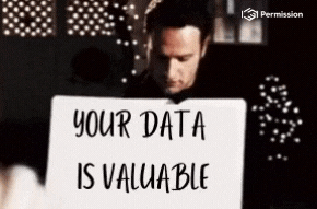 A man holding up a sign that reads 'Your data is valuable' to a woman who looks impressed.