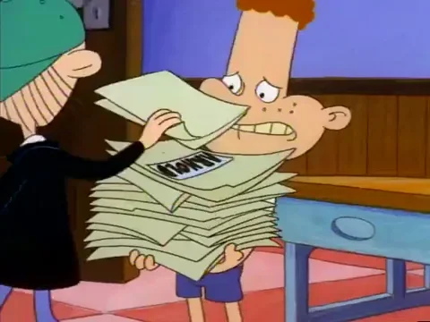 GIF of boy holding and then dropping a large pile of folders and documents