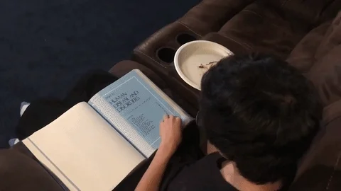 A person flipping quickly through a textbook. Studying College Student GIF by ODE Willie's Funky Bunch