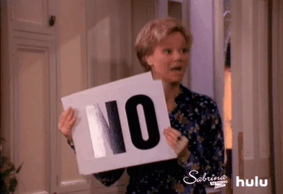 Woman saying no and displaying signs that say NO
