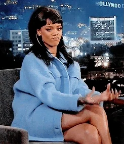 Rihanna doing 'pay me' gesture.