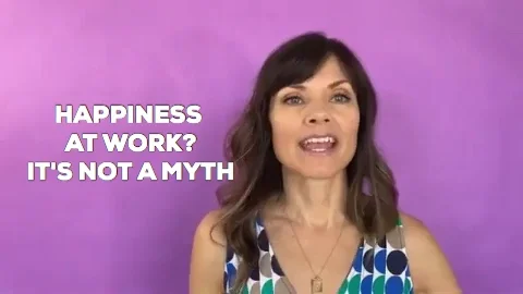 A woman wearing a polka-dot shirt in front of a purple background, saying 'Happiness at work? It's not a myth'