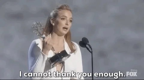 Actress Jodie Comer at the Emmys, holding her award and saying, 