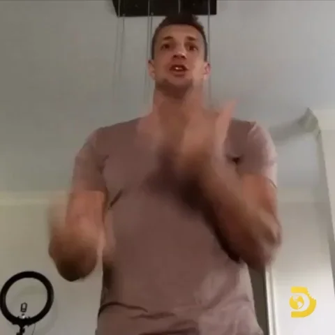 A man juggling multiple balls in the air.