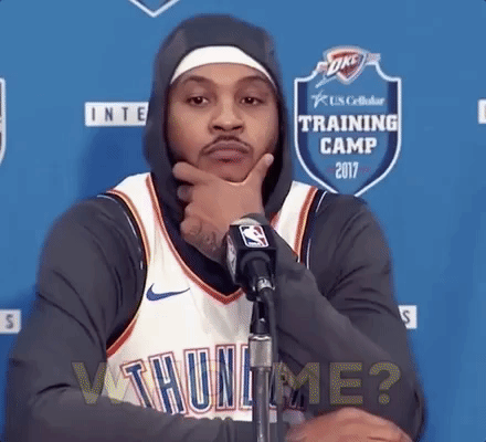 A basketball player at a press conference in front of a microphone. He says, 