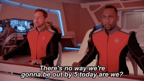Futuristic astronauts in a ship's control room. One asks, 