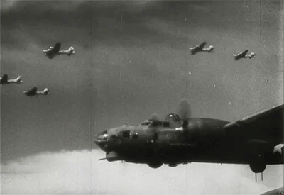 A fleet of US bombers fly through the sky.