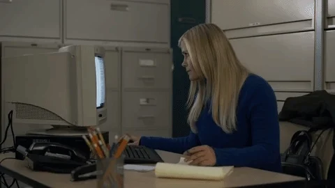 A woman looking for information on a computer.