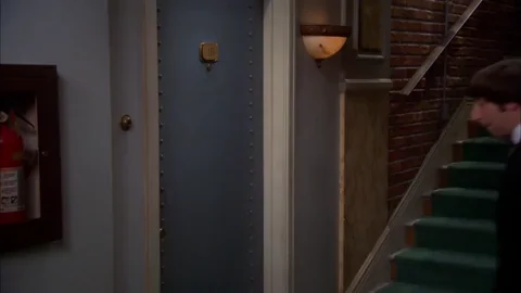 Simon Helberg as Howard from Big Bang Theory wearing a tuxedo and knocking on an apartment door.