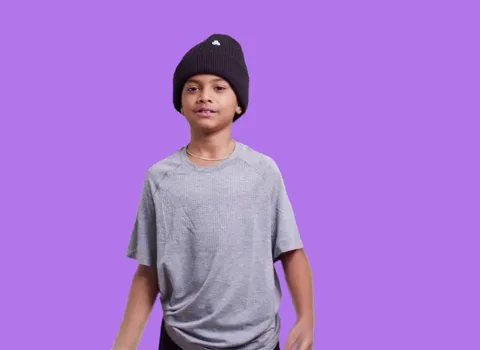 A boy flexes his muscles while saying, 