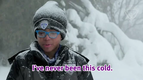 A boy wearing winter clothes stands in the snow, saying, “I’ve never been this cold.”