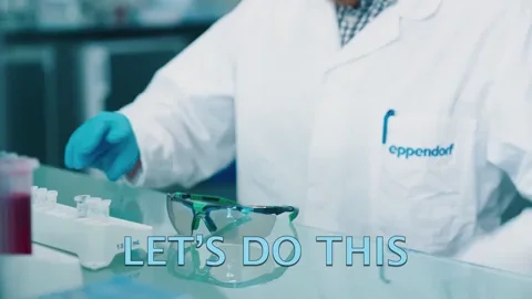 A man in the lab putting on goggles. The text reads: 