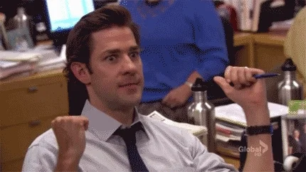 Jim from The Office pumps his fist with enthusiasm.