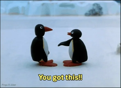Two penguins stand on snowy ground, reaching out to each other in a supportive gesture. The text reads: “You got this!!