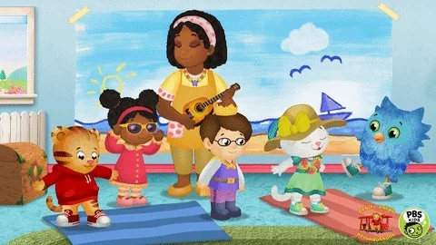 A cartoon dance party in a kindergarten classroom. The teacher plays a ukelele while the students dance.