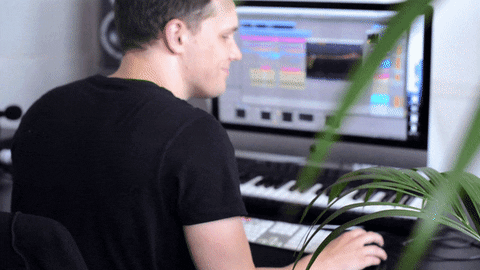 A music composer looking smug as they're using technology to produce music